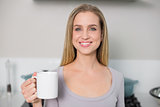 Happy gorgeous model holding mug