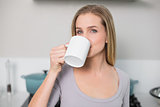 Calm gorgeous model drinking from mug