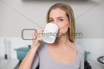 Calm gorgeous model drinking from mug