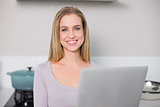 Smiling gorgeous model holding laptop