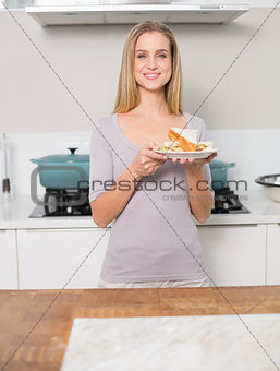 Happy gorgeous model holding plate with sandwich