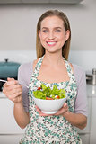 Smiling gorgeous model holding salad bowl