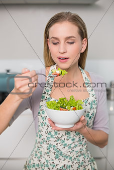 Happy gorgeous model eating salad