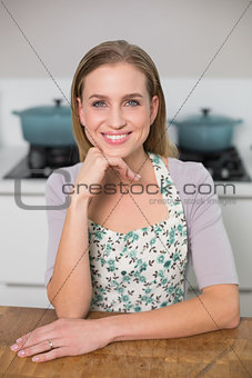 Cheerful gorgeous model sitting at table