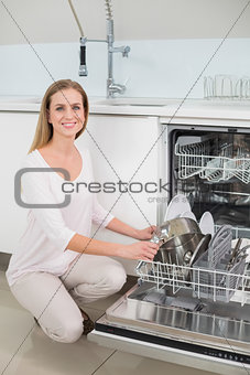 Lucky gorgeous model kneeling next to dish washer