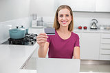 Gleeful casual woman using laptop and credit card
