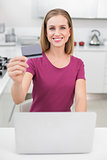 Blonde casual woman using laptop and credit card