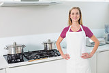 Casual smiling blonde standing next to stove