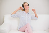 Laughing casual blonde listening to music