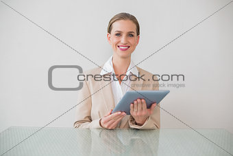 Smiling stylish businesswoman using tablet