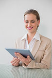 Happy stylish businesswoman using tablet