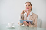 Content stylish businesswoman holding tablet