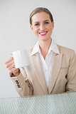 Happy stylish businesswoman holding mug