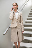 Stern stylish businesswoman phoning