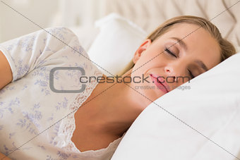 Natural calm woman sleeping in bed