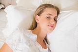 Natural content woman sleeping in bed