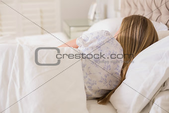 Natural woman slumbering in bed