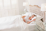 Natural calm woman resting in bed