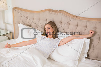Natural woman yawning and resting in bed