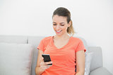 Attractive calm woman messaging with her smartphone