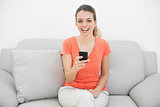 Gleeful calm woman laughing holding her smartphone
