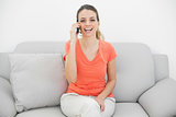 Gorgeous amused woman phoning with her smartphone laughing at camera