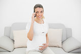 Expectant pregnant woman phoning with her smartphone