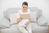 Cheerful pregnant woman holding her tablet