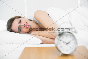 Content calm woman lying on her bed under the cover