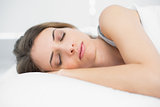 Peaceful sleeping woman lying on her bed