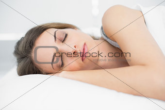 Peaceful sleeping woman lying on her bed