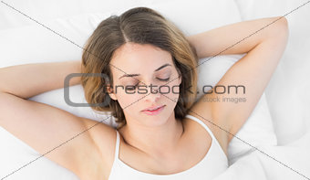 Overhead view of pretty calm woman sleeping lying on her bed