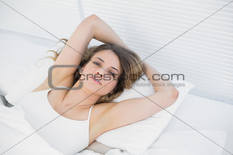 Attractive woman posing lying on her bed