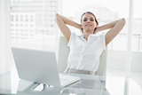 Relaxing classy businesswoman sitting on her swivel chair