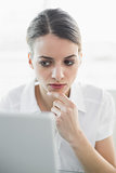Beautiful businesswoman sitting concentrating at her desk