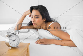 Exhausted young woman lying in her bed