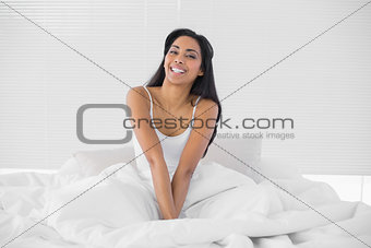Lovely calm woman stretching her arms out looking at camera