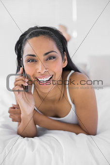 Beautiful smiling woman phoning with her smartphone