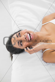 Lovely laughing woman phoning with her smartphone
