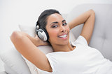 Content smiling woman listening to music smiling at camera
