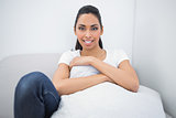 Beautiful smiling woman holding a pillow smiling at camera