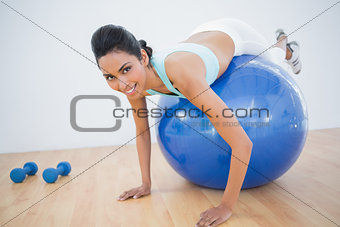 Lovely fit woman training on fitness ball