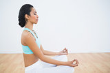 Attractive calm woman meditating sitting in lotus position