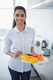 Beautiful proud woman showing vegetables smiling at camera