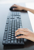 Close up of female hands working on computer
