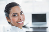 Beautiful smiling businesswoman sitting in bright office