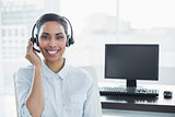 Cute smiling agent wearing headset looking at camera