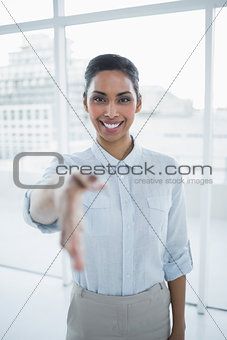 Content smiling businesswoman reaching her hand