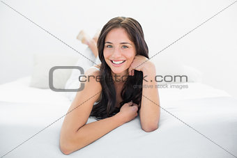 Smiling woman lying in bed