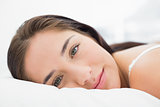 Close up of a pretty woman resting in bed